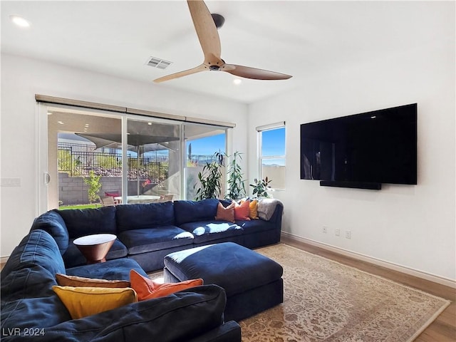 living room featuring hardwood / wood-style flooring and ceiling fan