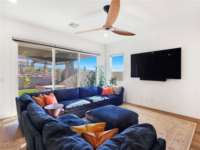 living room featuring hardwood / wood-style floors and ceiling fan