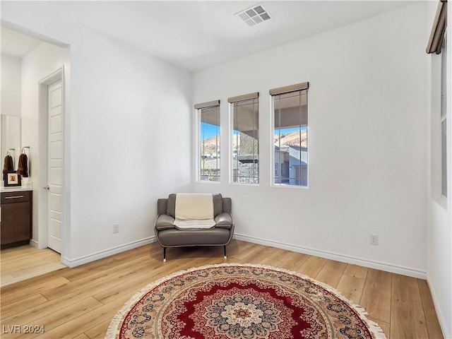 living area with light hardwood / wood-style flooring