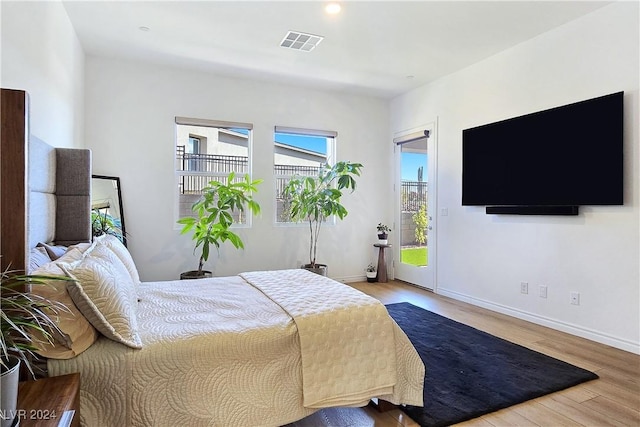 bedroom featuring access to outside and light wood-type flooring