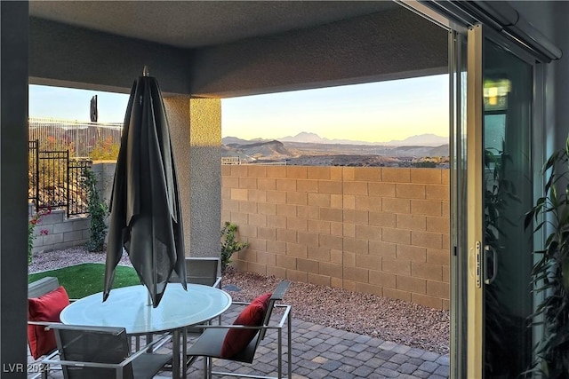 patio terrace at dusk with a mountain view