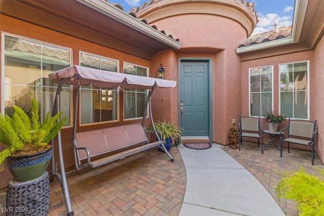 entrance to property with a patio area