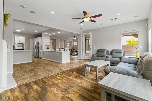 living room featuring ceiling fan and hardwood / wood-style flooring