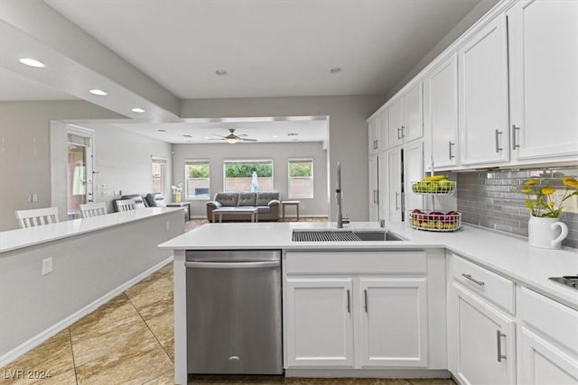 kitchen featuring dishwasher, sink, ceiling fan, decorative backsplash, and white cabinetry