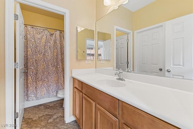 bathroom with walk in shower, tile patterned flooring, vanity, and toilet