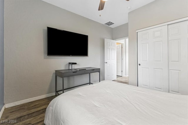 bedroom with ceiling fan, a closet, and dark hardwood / wood-style floors