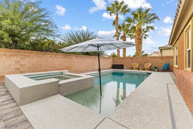 view of pool with an in ground hot tub