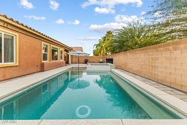 view of swimming pool with an in ground hot tub