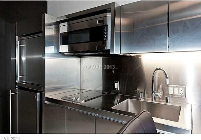 kitchen featuring decorative backsplash and sink