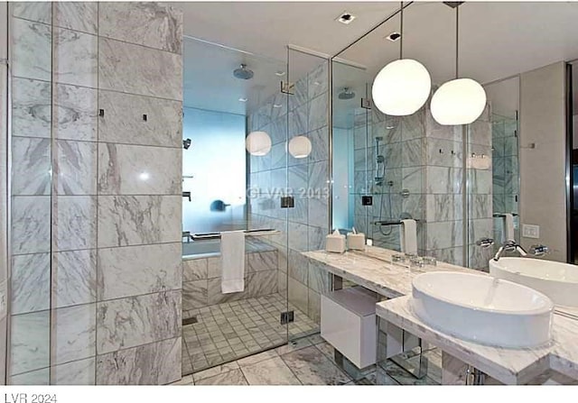 bathroom featuring sink, an enclosed shower, and tile walls