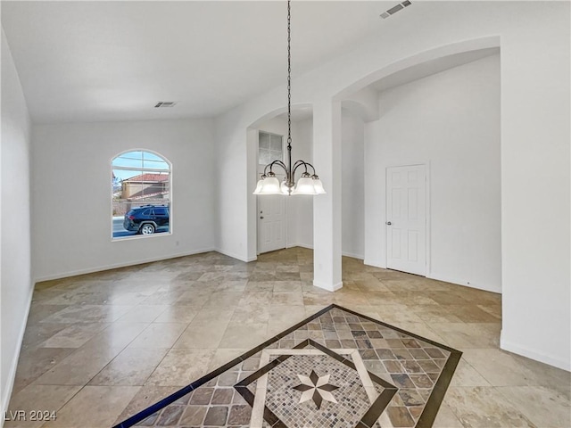 unfurnished dining area featuring an inviting chandelier