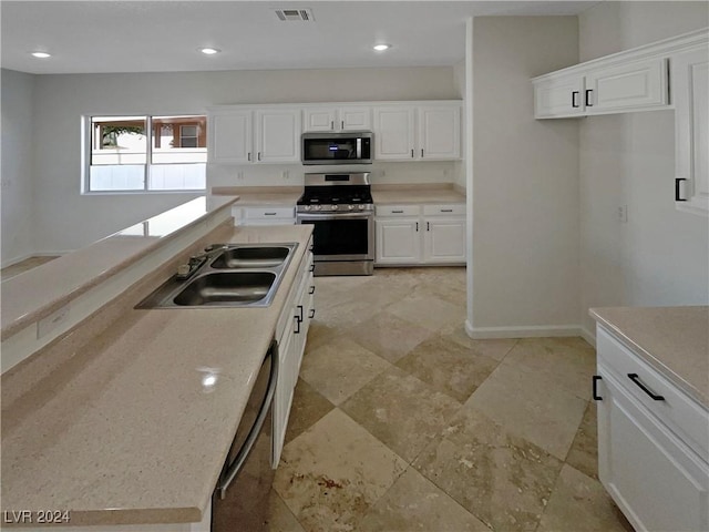 kitchen with white cabinetry, sink, and appliances with stainless steel finishes