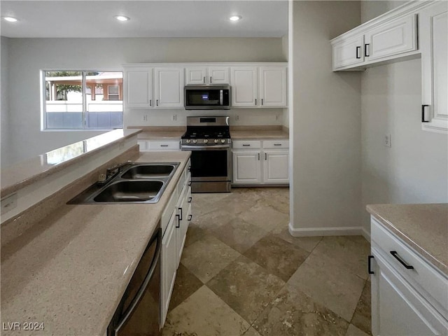 kitchen with white cabinetry, sink, and appliances with stainless steel finishes