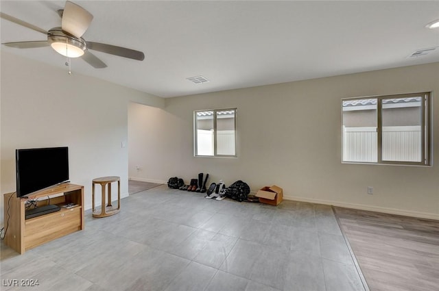 interior space with a wealth of natural light and ceiling fan