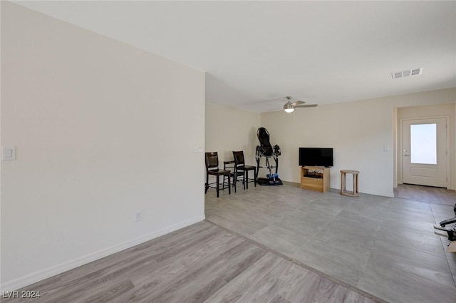 living room featuring ceiling fan and light wood-type flooring