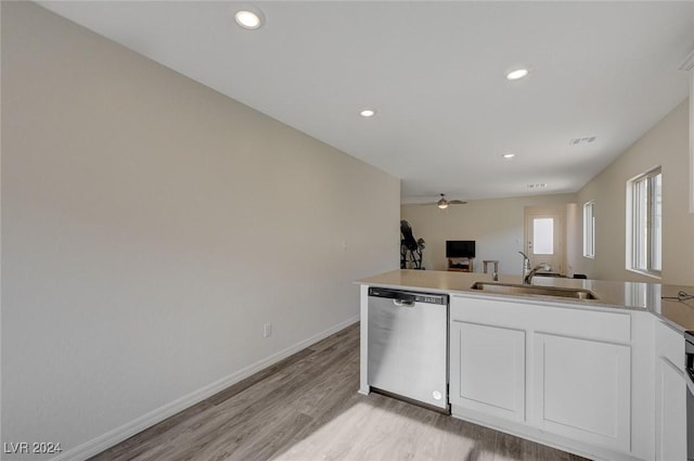 kitchen with light wood-type flooring, white cabinets, ceiling fan, sink, and dishwasher