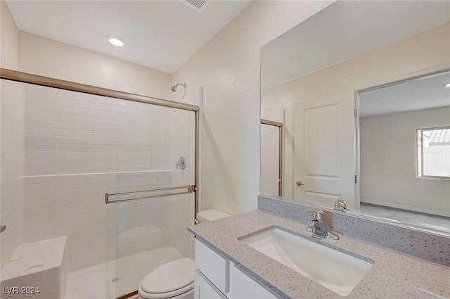 bathroom with vanity, toilet, and an enclosed shower