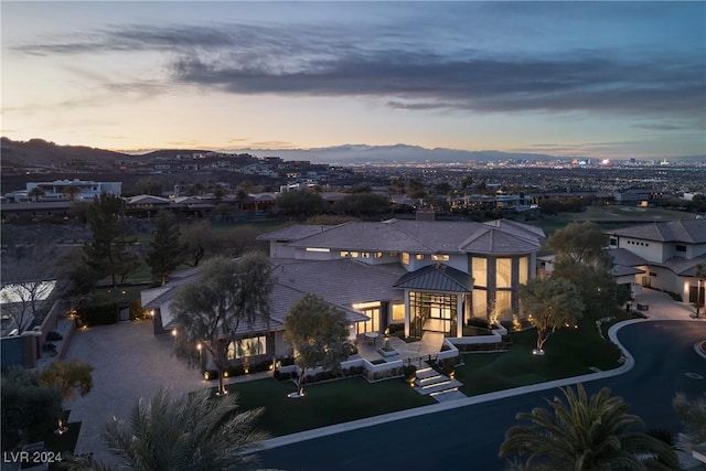 back house at dusk with a mountain view