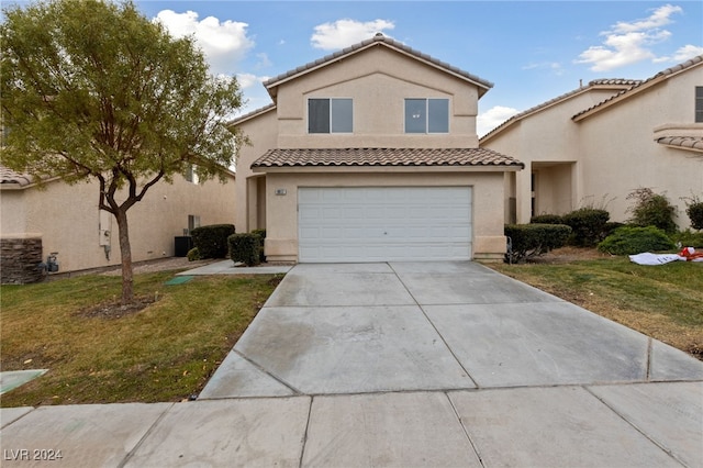 view of front of home with a garage and a front yard