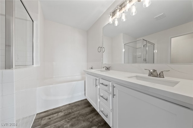 bathroom with hardwood / wood-style floors, vanity, and separate shower and tub