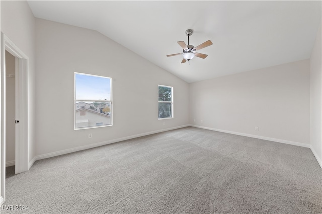 empty room with light carpet, ceiling fan, and lofted ceiling