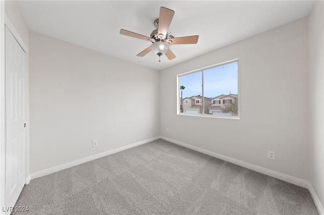 empty room with ceiling fan and carpet floors