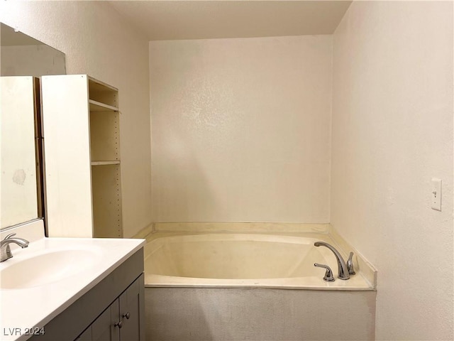 bathroom with a washtub and vanity