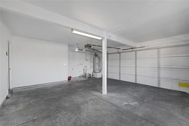 garage featuring strapped water heater and a garage door opener