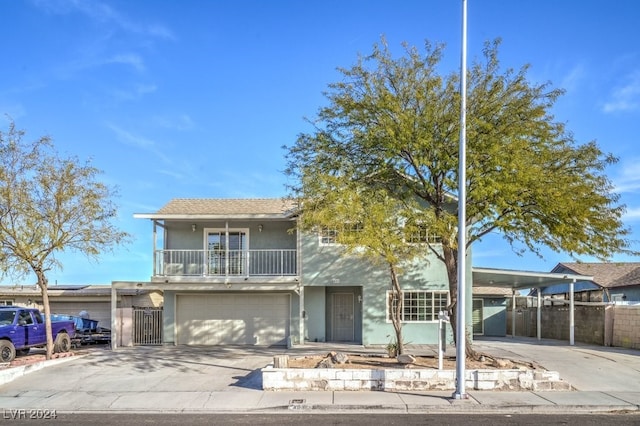 view of front of property featuring a balcony and a garage