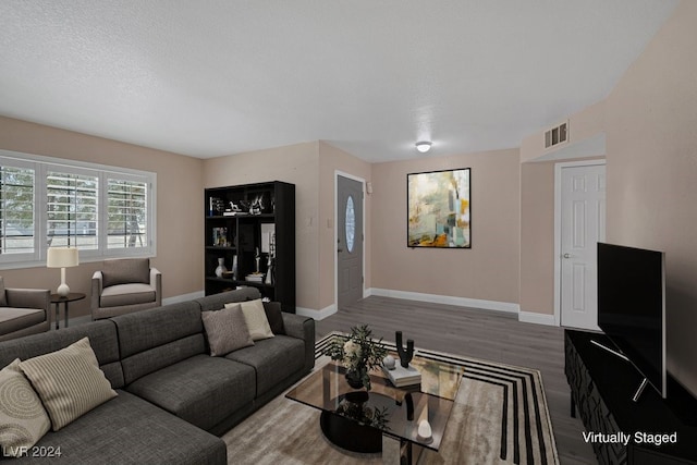 living room with hardwood / wood-style floors and a textured ceiling