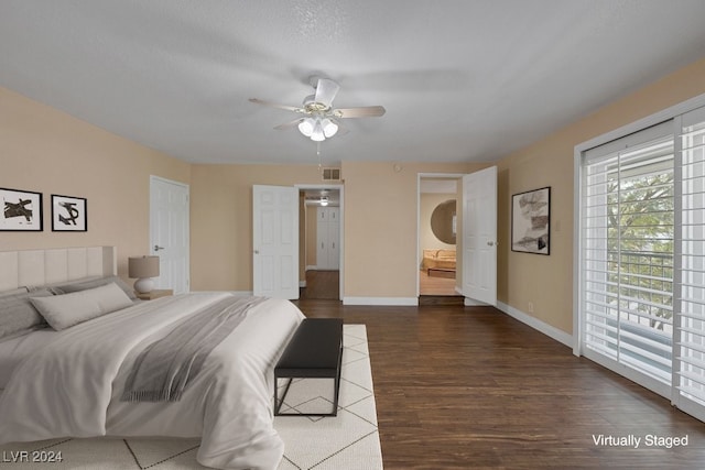 bedroom featuring dark hardwood / wood-style floors, ceiling fan, and a textured ceiling