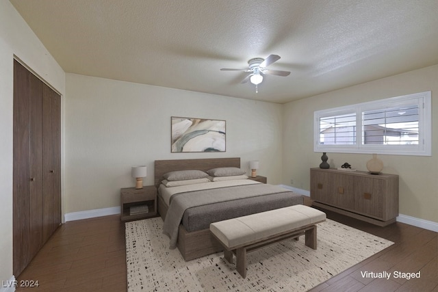 bedroom featuring hardwood / wood-style flooring, ceiling fan, a textured ceiling, and a closet