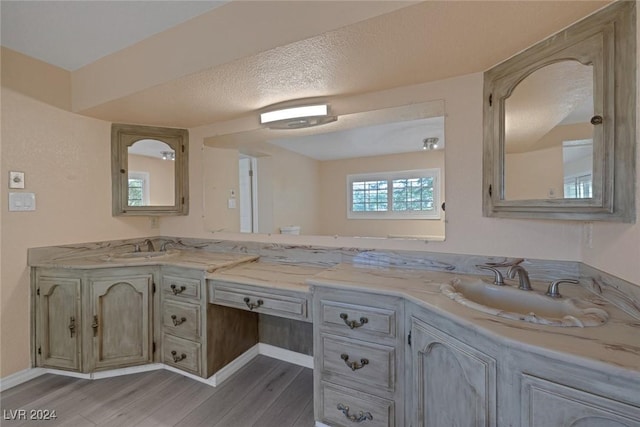 bathroom with vanity, a textured ceiling, and hardwood / wood-style flooring