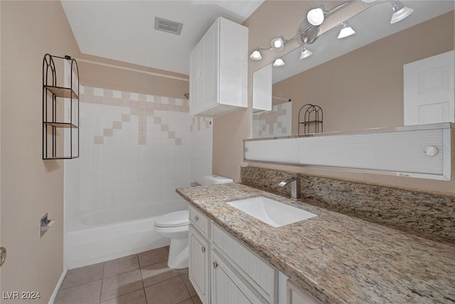 full bathroom featuring tile patterned floors, vanity, tiled shower / bath combo, and toilet