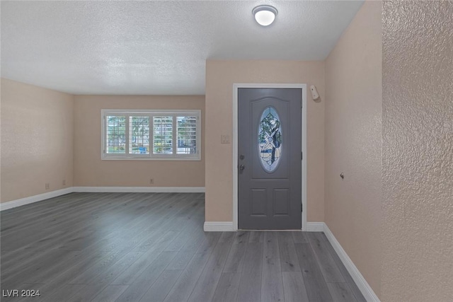 foyer with hardwood / wood-style floors and a textured ceiling