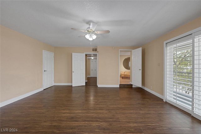 empty room with ceiling fan and dark hardwood / wood-style floors