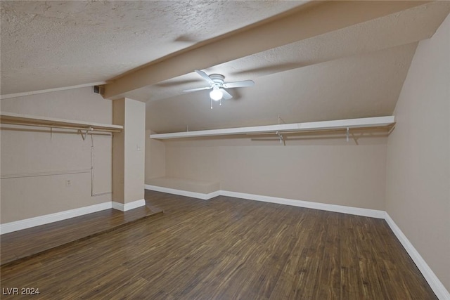 walk in closet featuring dark hardwood / wood-style flooring, ceiling fan, and lofted ceiling