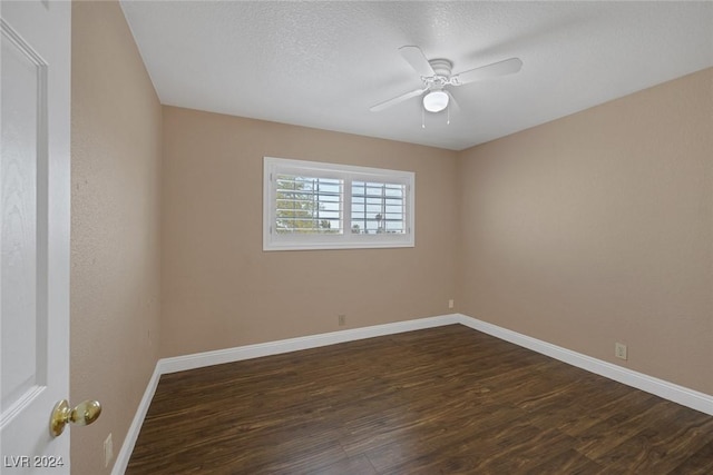 spare room with a textured ceiling, ceiling fan, and dark hardwood / wood-style floors