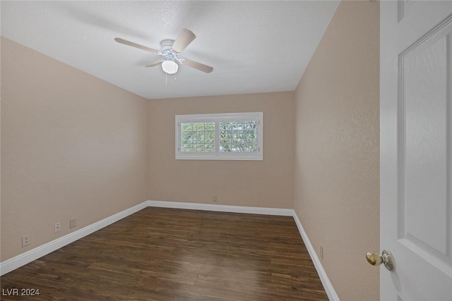 spare room featuring dark hardwood / wood-style flooring and ceiling fan