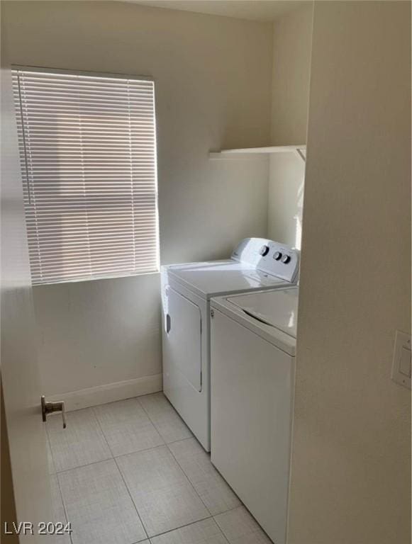 laundry area featuring light tile patterned floors and separate washer and dryer