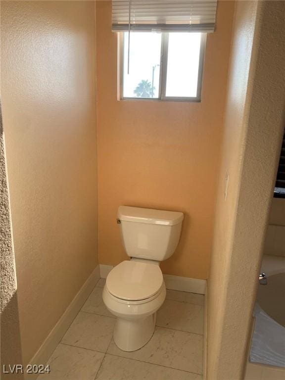 bathroom featuring toilet and tile patterned floors