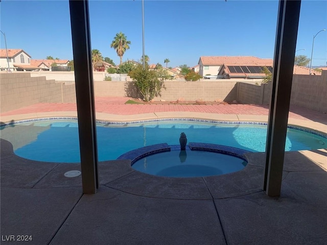 view of pool with an in ground hot tub