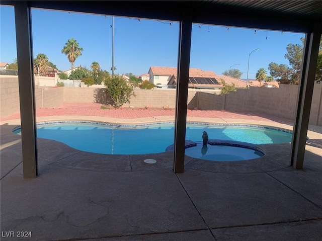 view of swimming pool featuring an in ground hot tub