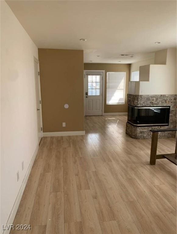 unfurnished living room featuring light wood-type flooring