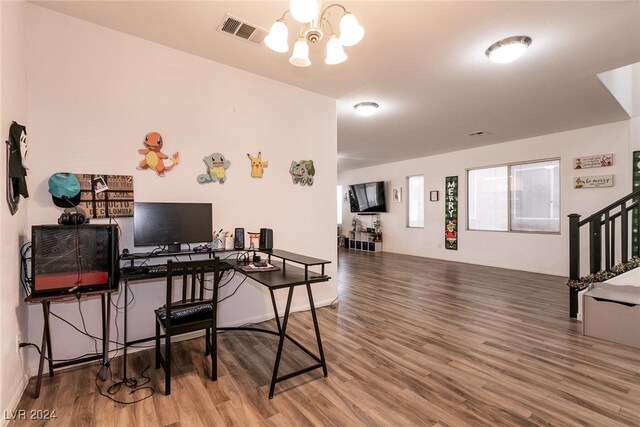 interior space with wood-type flooring and a notable chandelier