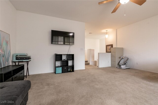 living room with ceiling fan and light colored carpet