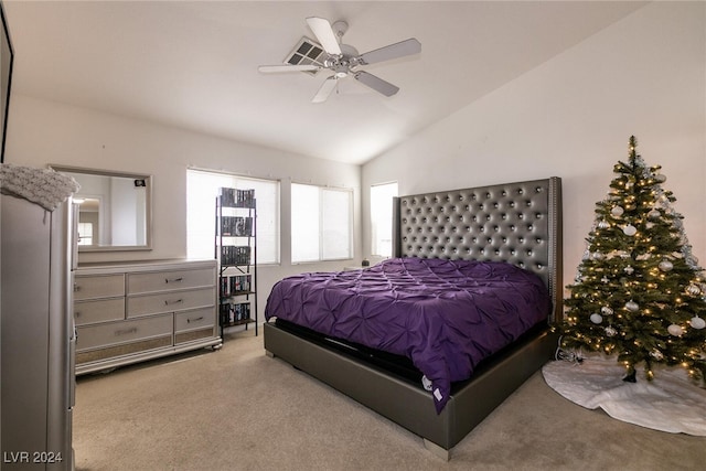 carpeted bedroom with ceiling fan and lofted ceiling