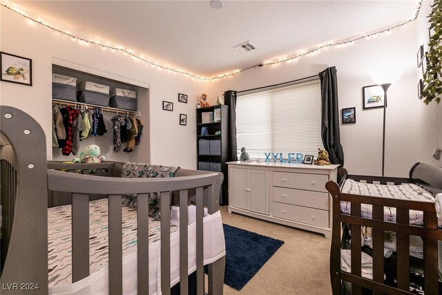 bedroom with light carpet and a closet