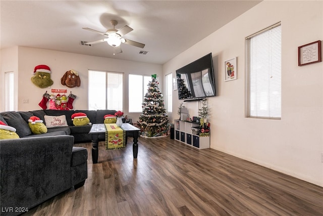 living room with dark hardwood / wood-style flooring and ceiling fan