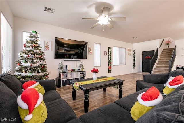 living room featuring ceiling fan and hardwood / wood-style flooring